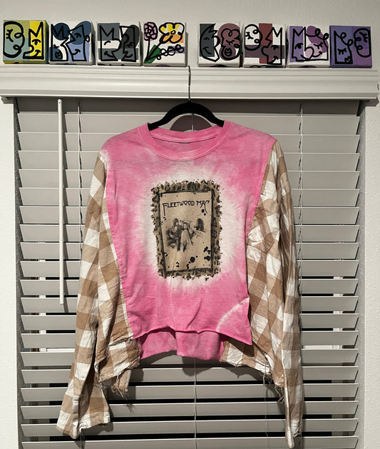 Pink tie-dye sweatshirt with graphic design on a hanger against a white background