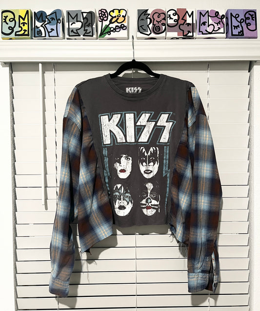 Gray 'KISS' t-shirt with plaid shirt over it on a white wooden background