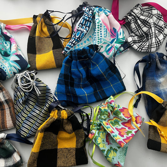 Collection of colorful drawstring bags on a white background